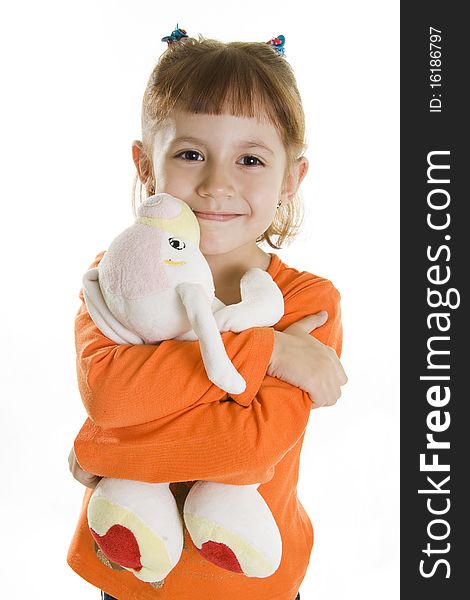 Little girl plays with a soft toy. A white background. Little girl plays with a soft toy. A white background.