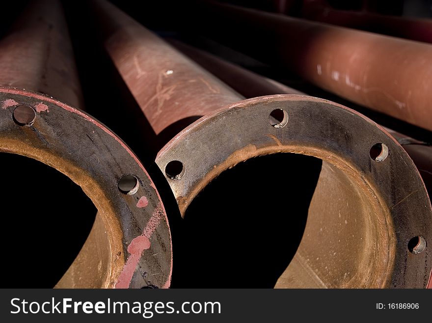 Old rusty pipes in a pile in a construction yard. Old rusty pipes in a pile in a construction yard