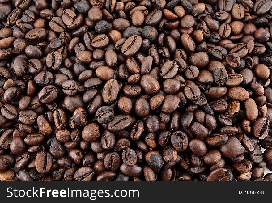 A wallpaper of freshly roasted coffe beans filling the entire screen. A wallpaper of freshly roasted coffe beans filling the entire screen