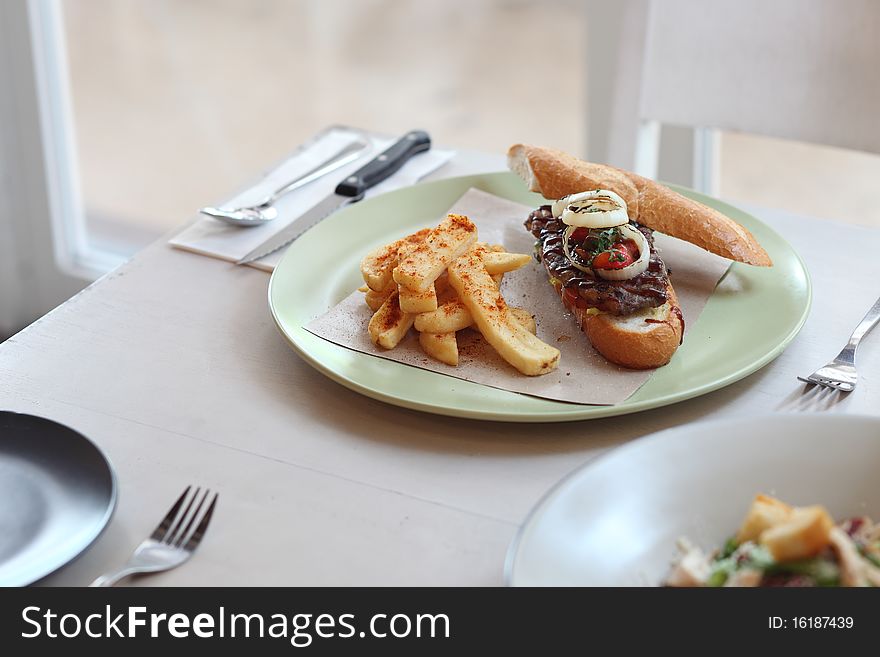 A plate of beef sandwich with french fried