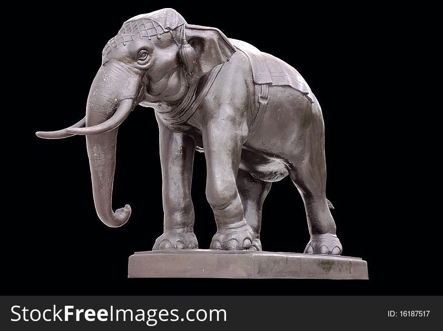 An artistic and realistic sculpture of an elephant isolated on black background. An artistic and realistic sculpture of an elephant isolated on black background.