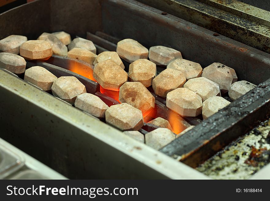 A grill oven with hot stones and fire