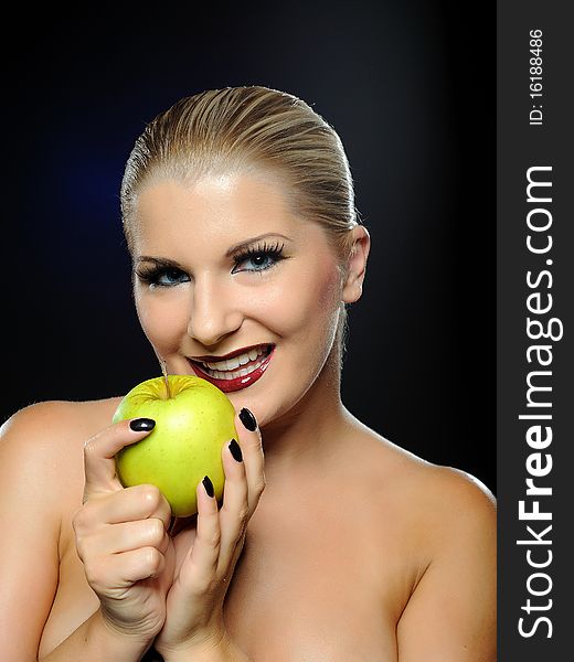 Beautiful woman with bright make-up holding green apple. Beautiful woman with bright make-up holding green apple