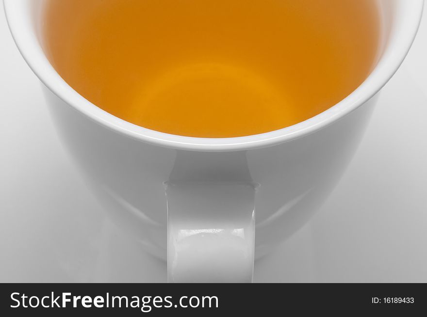 A cup of green tea on a white cup on a white background