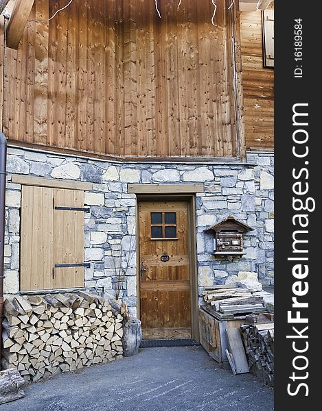 This image shows the front of a log cabin. This image shows the front of a log cabin