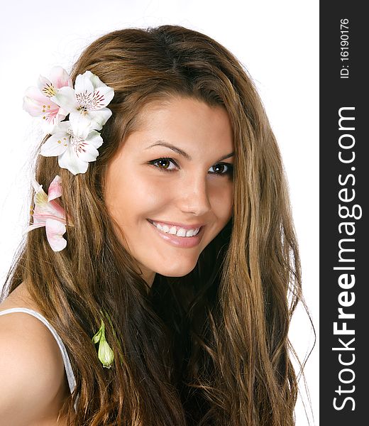 Smiling beautiful young girl with flowers in hair. Smiling beautiful young girl with flowers in hair