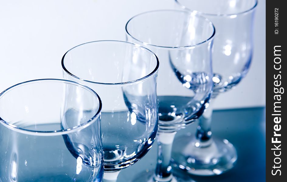 Row of clean empty wineglasses on the white background. Row of clean empty wineglasses on the white background