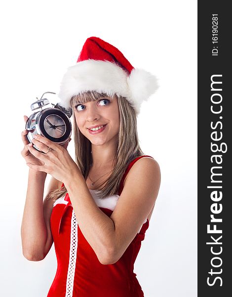 Santa girl holding a clock, alarm clock and wondering. Holidays New Year and Christmas