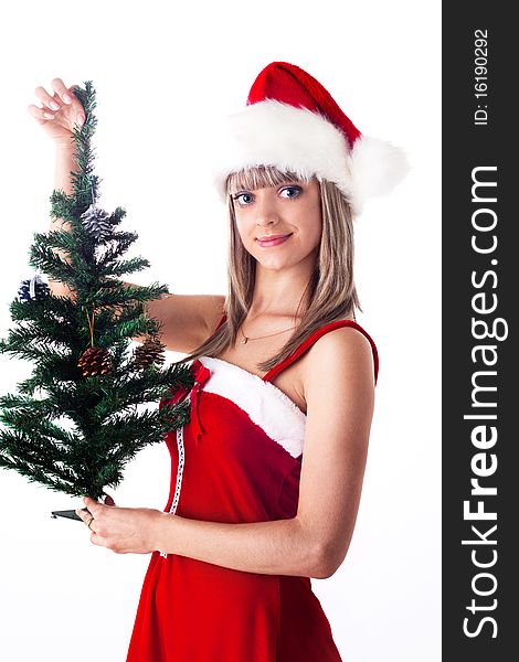 Santa girl holding a Christmas tree with cones and toys. Holidays New Year and Christmas