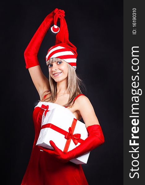 Santa girl holding a great gift. Holidays New Year and Christmas