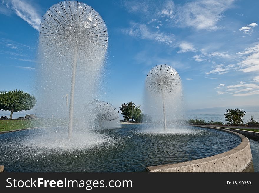 Nice fountain in the town of Romanshorn, Switzerland, Lake Constance  in background