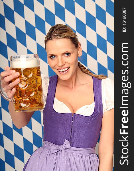 Beautiful bavarian woman holding a beer