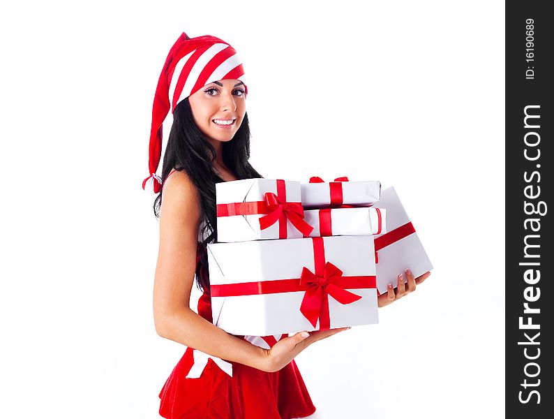 Beautiful young brunette woman dressed as Santa with presents in her hands. Beautiful young brunette woman dressed as Santa with presents in her hands