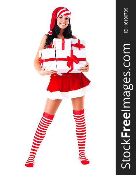 Beautiful young brunette woman dressed as Santa with presents in her hands. Beautiful young brunette woman dressed as Santa with presents in her hands