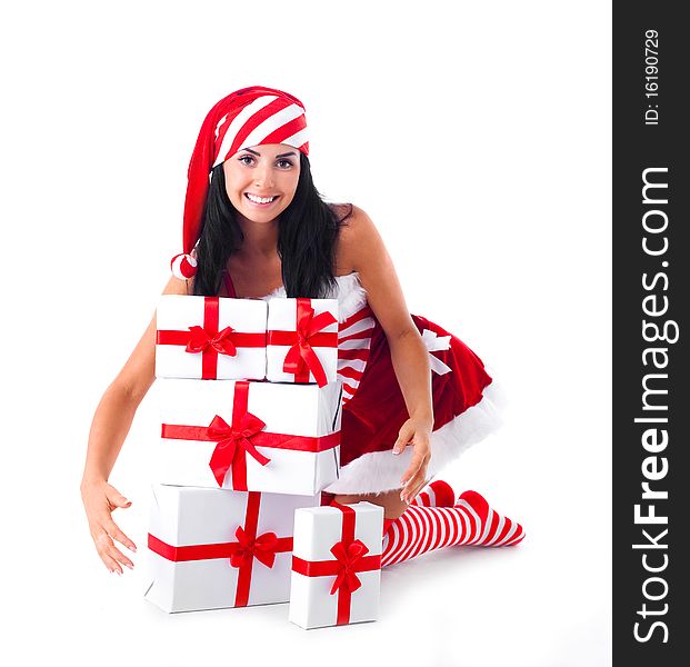 Beautiful young brunette woman dressed as Santa sitting on the floor with a lot of presents. Beautiful young brunette woman dressed as Santa sitting on the floor with a lot of presents