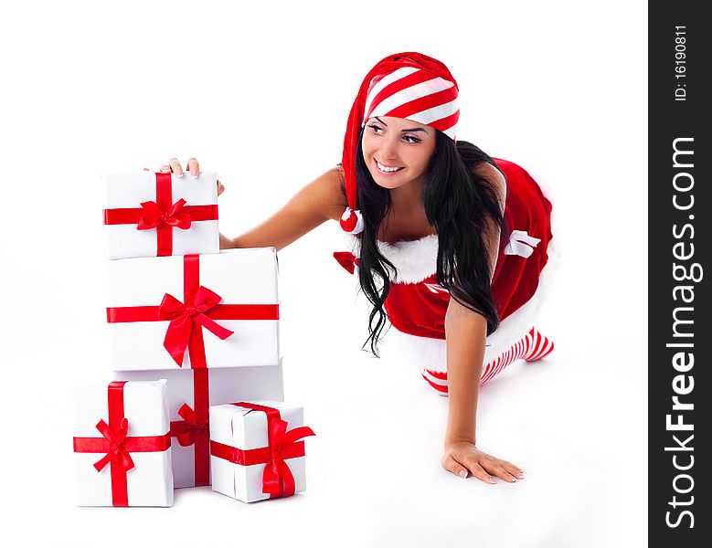 Beautiful young brunette woman dressed as Santa sitting on the floor with a lot of presents. Beautiful young brunette woman dressed as Santa sitting on the floor with a lot of presents