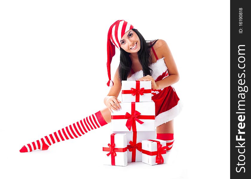 Beautiful young brunette woman dressed as Santa sitting on the floor with a lot of presents. Beautiful young brunette woman dressed as Santa sitting on the floor with a lot of presents