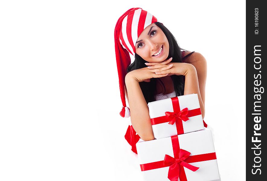 Beautiful young brunette woman dressed as Santa sitting on the floor with a lot of presents. Beautiful young brunette woman dressed as Santa sitting on the floor with a lot of presents