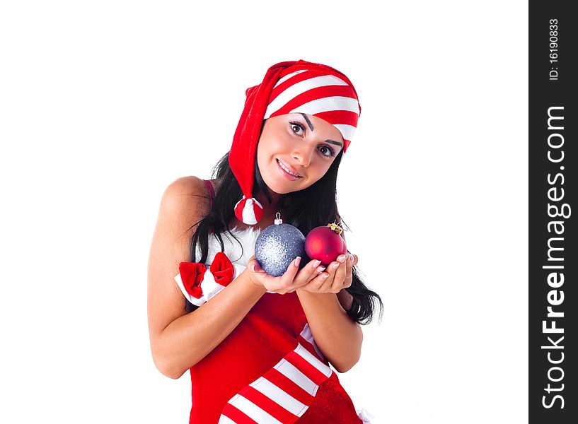 Happy beautiful girl dressed as Santa holding decorations for the fir tree