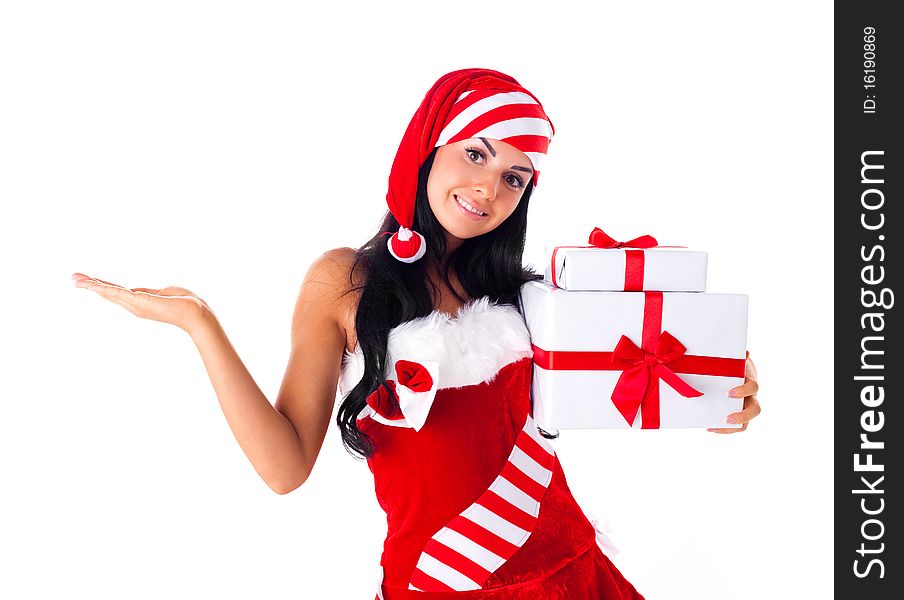 Beautiful young brunette woman dressed as Santa with presents in her hands and her hand up-place your product here. Beautiful young brunette woman dressed as Santa with presents in her hands and her hand up-place your product here