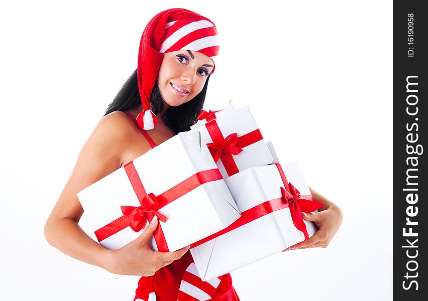 Beautiful young brunette woman dressed as Santa with presents in her hands. Beautiful young brunette woman dressed as Santa with presents in her hands