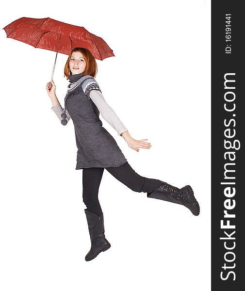 Girl holding red umbrella and jumping