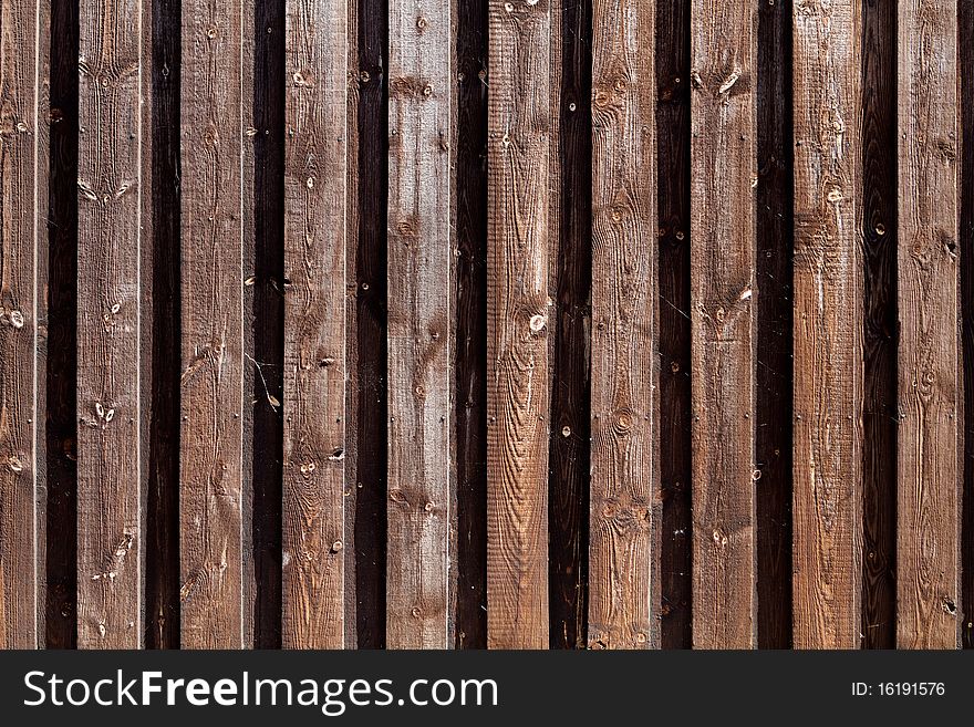 Natural colored wooden fence around industrial area