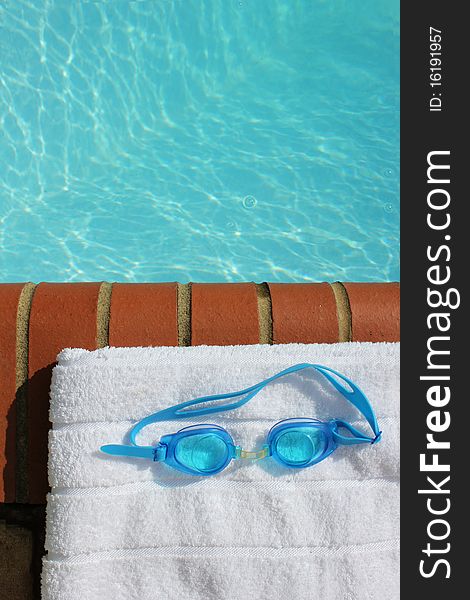 Goggles At The Edge Of A Swimming Pool