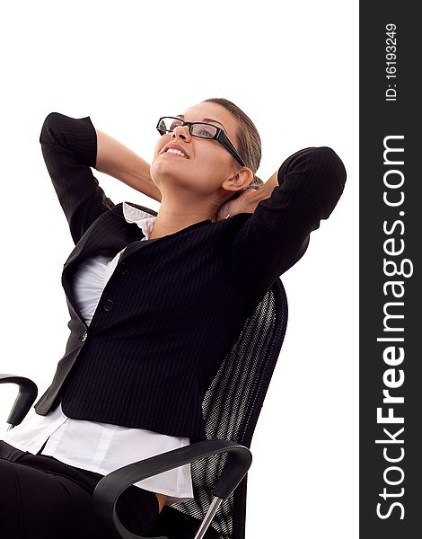 A business woman leaning back in a black chair dreaming. A business woman leaning back in a black chair dreaming