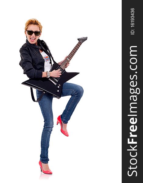 The beautiful blonde girl wearing leather jacket with a guitar and a leg up. The beautiful blonde girl wearing leather jacket with a guitar and a leg up