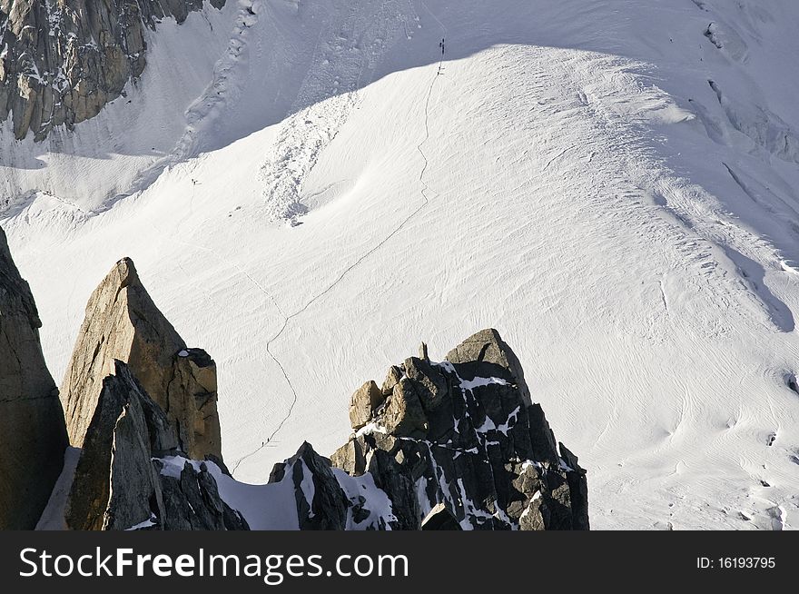From the top of l'Aiguille du Midi (3842 m), the views of the Alps are spectacular. In this picture you can see one of the paths that lead to the summit of Mont-Blanc. From the top of l'Aiguille du Midi (3842 m), the views of the Alps are spectacular. In this picture you can see one of the paths that lead to the summit of Mont-Blanc