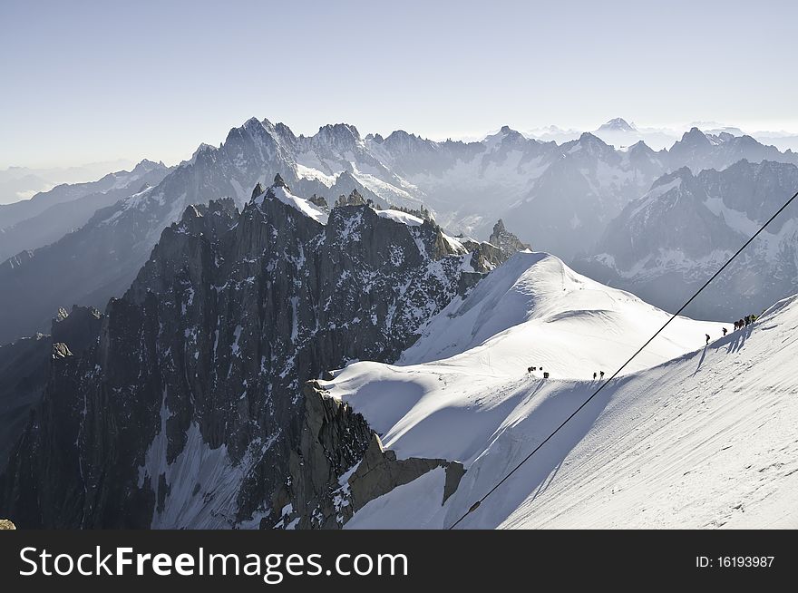 From the summit of l'Aiguille du Midi (3,842 m), the views of the Alps are spectacular. Descent of the climbers from l'Aiguille du Midi, to the Plan du Midi, much more below. From the summit of l'Aiguille du Midi (3,842 m), the views of the Alps are spectacular. Descent of the climbers from l'Aiguille du Midi, to the Plan du Midi, much more below.