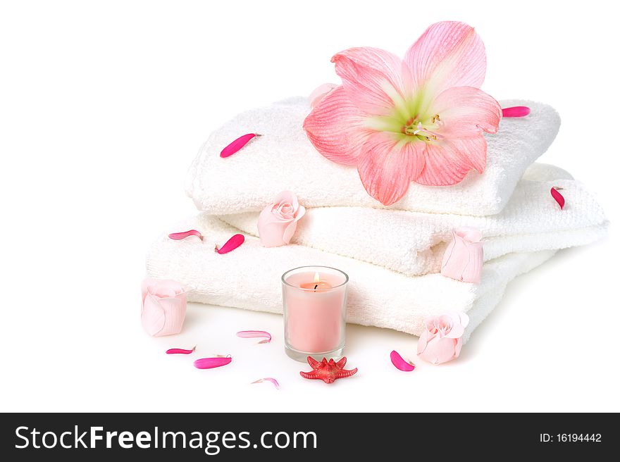 White towels with pink soap roses and candle on white background. White towels with pink soap roses and candle on white background