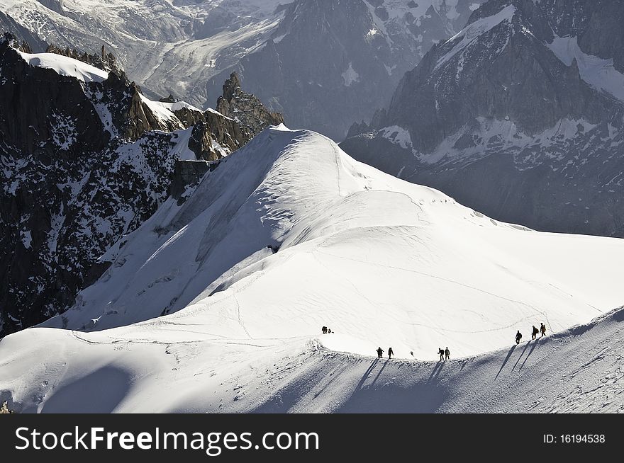 From the summit of l'Aiguille du Midi (3,842 m), the views of the Alps are spectacular. In this picture, you can see the descent of the mountain, along the ridge. From the summit of l'Aiguille du Midi (3,842 m), the views of the Alps are spectacular. In this picture, you can see the descent of the mountain, along the ridge.