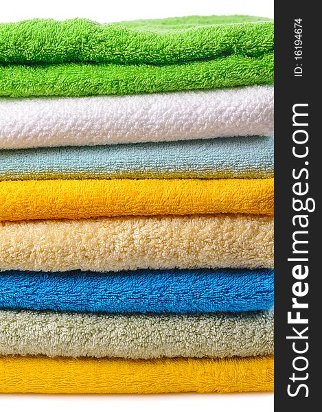 Stack of colorful towels isolated on white. Stack of colorful towels isolated on white