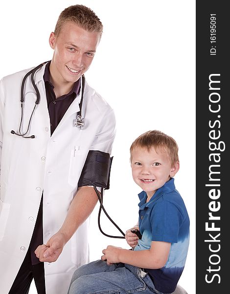 A male doctor letting his young boy patient check his blood pressure. A male doctor letting his young boy patient check his blood pressure.