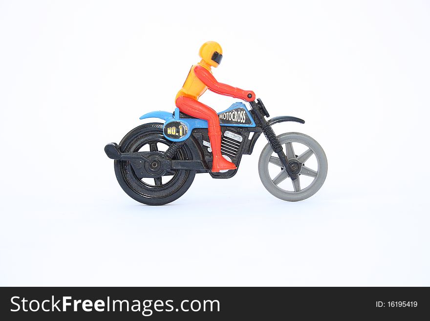 Toy pull racer plastic bike with rider isolated on white background. Toy pull racer plastic bike with rider isolated on white background