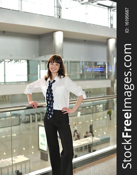 Business young woman standing in office environment. Business young woman standing in office environment