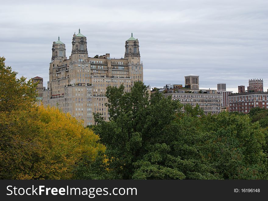 This is a view of the Manhattan skyline over some trees. This is a view of the Manhattan skyline over some trees.