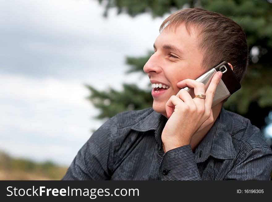 Portrait of casual young man talking on cellphone. Portrait of casual young man talking on cellphone