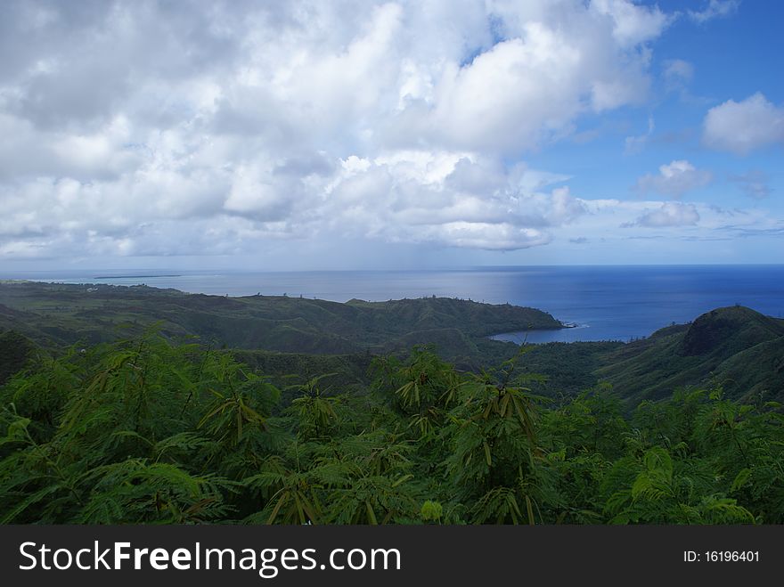 Taken in Guam looking down at the ocean with a lush portion of a tropical rain forest in the foreground. Taken in Guam looking down at the ocean with a lush portion of a tropical rain forest in the foreground.