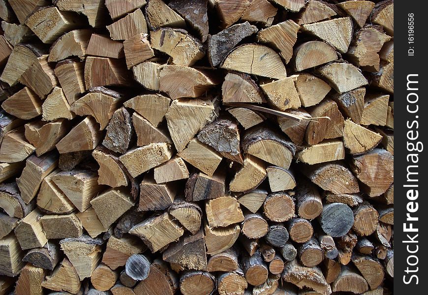Woodpile behind a fence in cellar