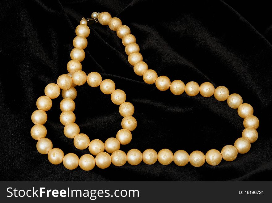 Woman necklace isolated on the black background
