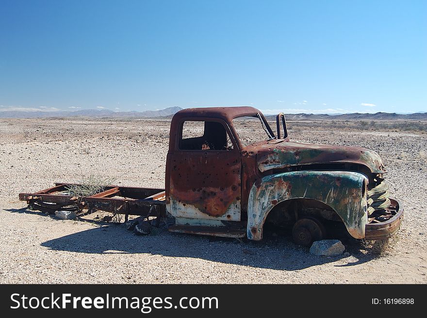 Truck in the Namibian desert riddled with bullet holes. Truck in the Namibian desert riddled with bullet holes