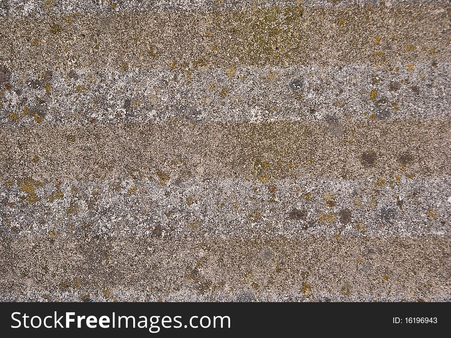 Stone wall used as a wall of a house of great old building in the background