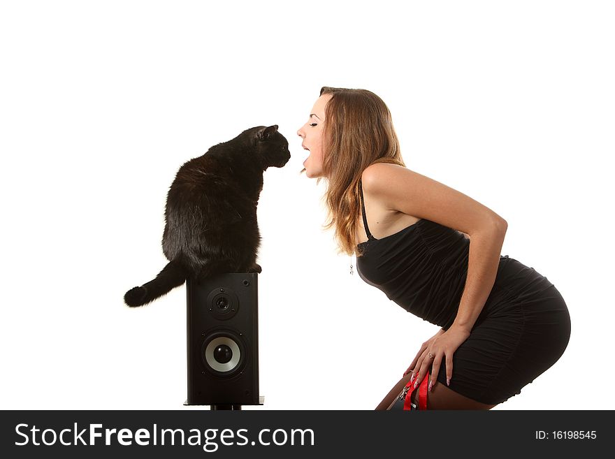 A black cat looks into the girls mouth. A black cat looks into the girls mouth