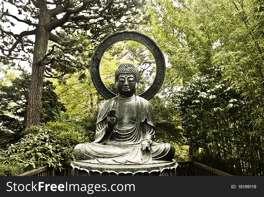 An aged Buddha statue rests quietly in the forest. An aged Buddha statue rests quietly in the forest.