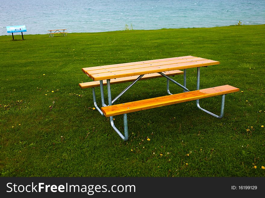 Bench and green lawn at a park. Bench and green lawn at a park