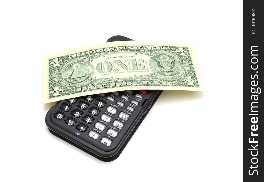 The black calculator on a white background and on it lies one dollar a denomination. The black calculator on a white background and on it lies one dollar a denomination