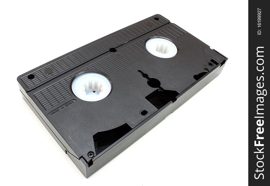 The black old videocassette costs on a white background an underside upwards. The black old videocassette costs on a white background an underside upwards